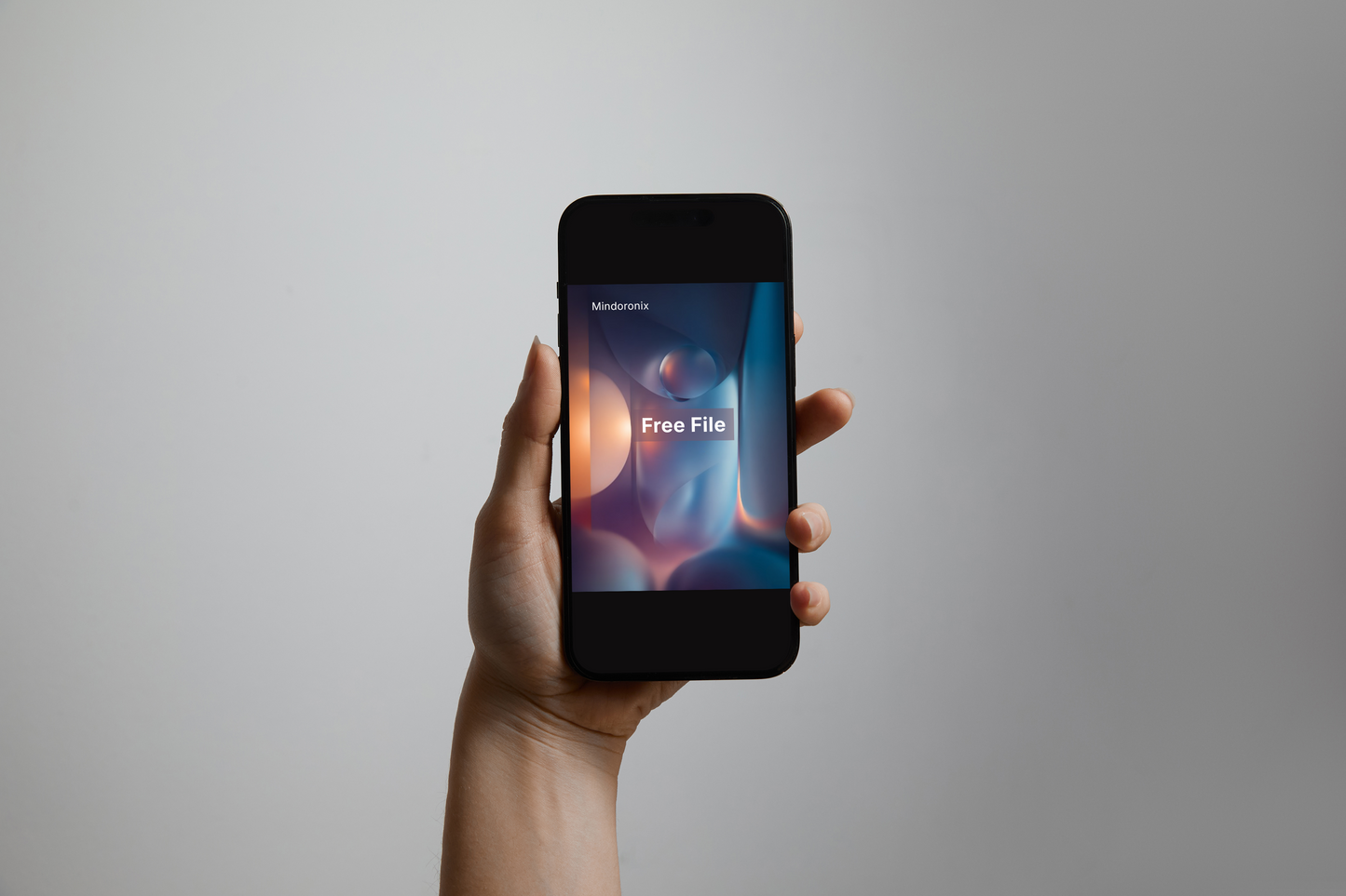 Hand holding a smartphone with a 'Free File' app on a gray background